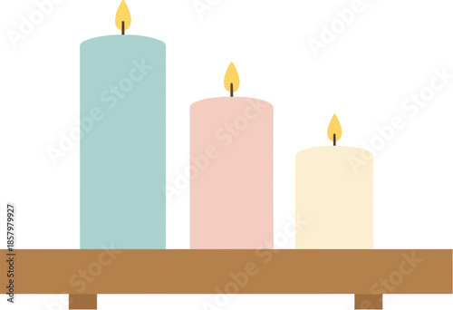 Three colorful pastel pillar candles burning on a wooden shelf.