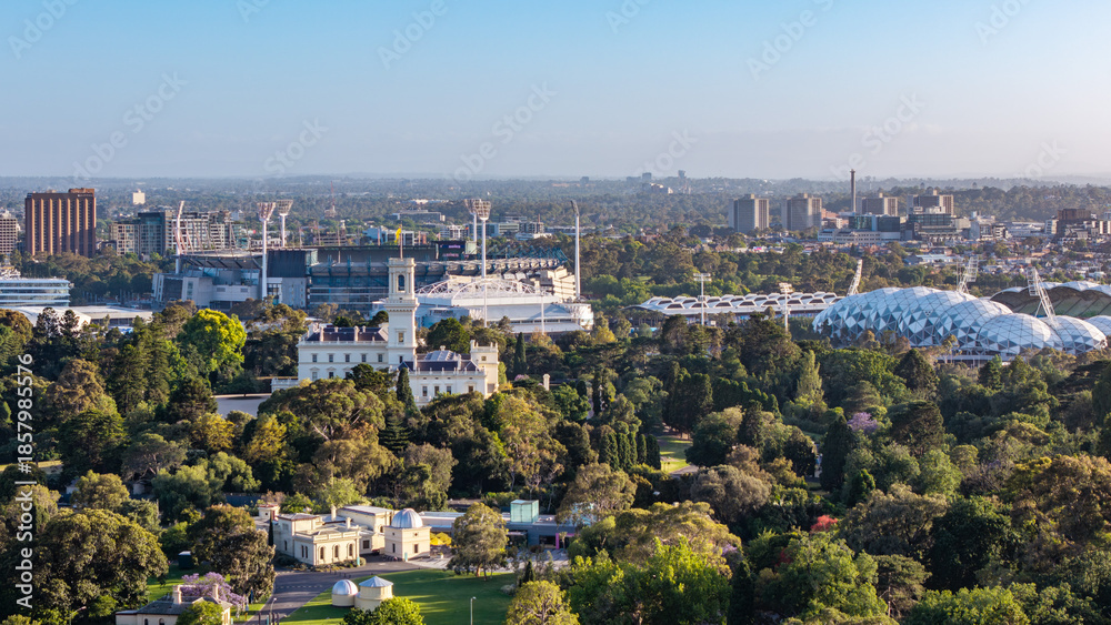 Fototapeta premium Panoramic Daytime View of Melbourne, Australia, Featuring Historic Government House, Lush Royal Botanic Gardens, and Major Sports Stadiums