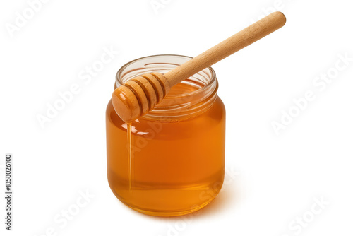 Honey in glass jar with wooden dipper