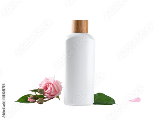 White cosmetic bottle with pink rose and green leaves on white background.