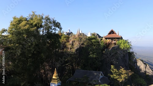 Aerial video view from a high mountain overlooking a beautiful tourist attraction in Lampang, Thailand Wat Chalerm Phra Kiat (Wat Phra Phutthabat Sutthawas),featuring an ancient pagoda and a nature.