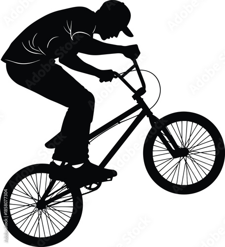 Action Silhouette of a Young Male Biker Performing a Wheelie Stunt on a BMX Bike for Extreme Sports and Urban Lifestyle