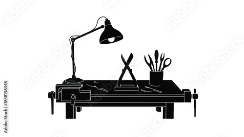 Artisan's workbench illuminated by a desk lamp, showcasing tools for precision crafting.