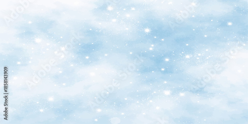 Abstract blue Christmas background featuring winter bokeh lights and glittery snowflakes for a cold seasonal holiday celebration design