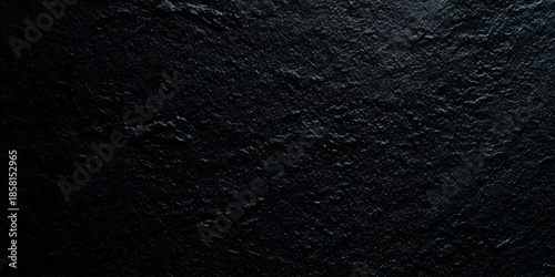 A darkly textured background reveals a rough uneven surface possibly stone or volcanic rock with subtle tonal variations