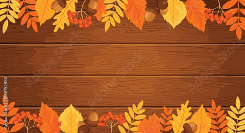 Autumn seasonal background featuring colorful fallen leaves, acorns, and rowan berries frame on dark wooden planks with copy space.