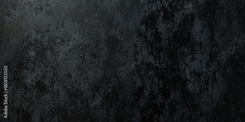 A dark textured background displaying a mottled surface with subtle variations in shade and tone
