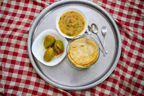 Authentic Black Sea region home dinner featuring organic stuffed green peppers, vegetable soup, and crispy pastry. A calm, natural table setting promoting a balanced lifestyle and mindfulness.  Natura