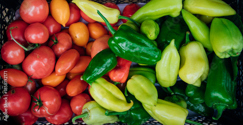 Ripe green pepper and red tomato, collected in a box. Autumn harvest.