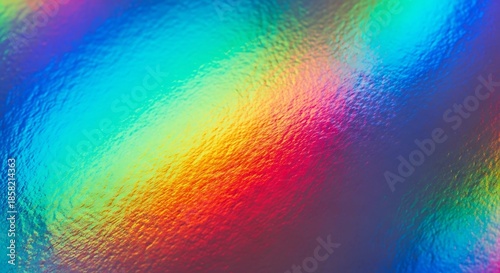 Close-up of a vibrant holographic surface displaying a full spectrum of rainbow colors with a textured, crinkled appearance.