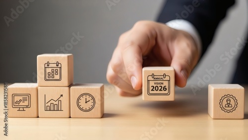 Annual Business Planning 2026 Vision. Hand placing calendar block with strategy icons, symbolizing long term vision strategic alignment and future focused corporate planning.

