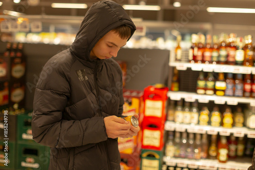 Εκτύπωση καμβά young man checking phone in supermarket aisle, inspecting jar label while standi