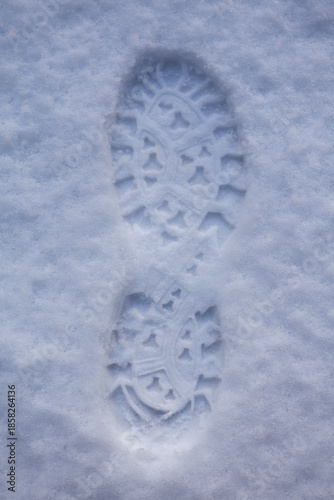 Single boot print in fresh snow with star tread pattern
