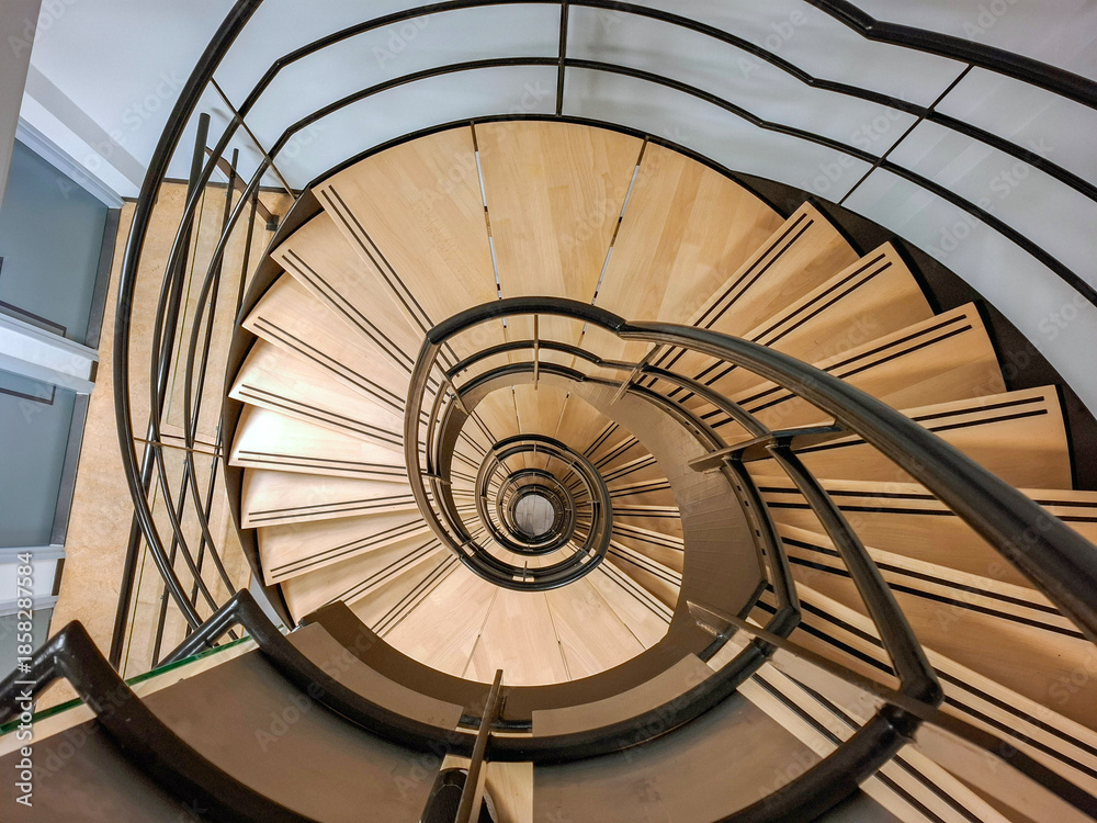Fototapeta premium Round staircase with wooden steps in building