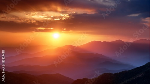 Sunset over rolling mountains with colorful sky and clouds in the background during evening