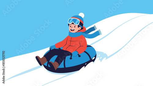 Happy young boy in winter gear sliding down a snowy hill on a blue inflatable tube against a bright blue sky.