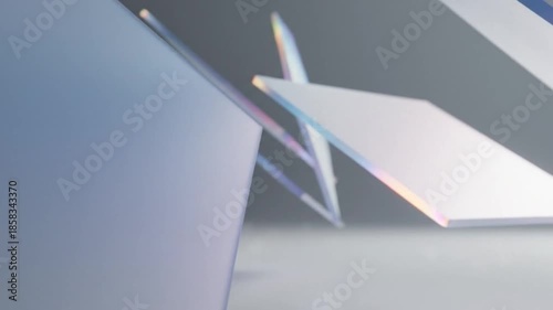 Close-up shot of overlapping white paper sheets with soft natural light and subtle pastel hues on a plain gray surface.