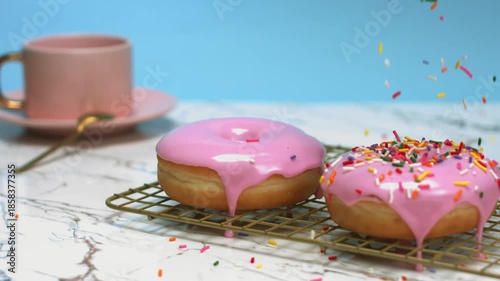 Pink Donuts with Sprinkles and a Cup of Coffee