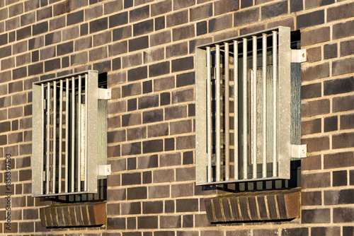 Tableau sur toile barred and opaque windows in building wall