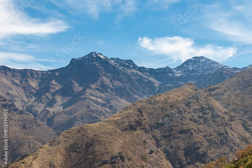 Breathtaking panoramic scenery of La Alcazaba and Pico del Mulhacen towering over the rugged valley, captured from the Vereda de la Estrella trail in the heart of Sierra Nevada, Andalusia, Spain.