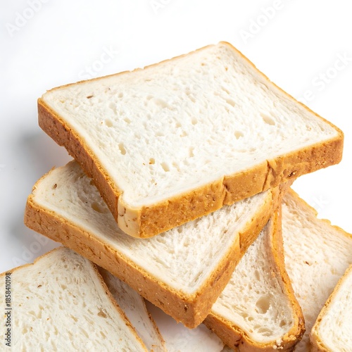 Slices of bread stacked on a white surface, displaying varied textures & patterns within the porous interior