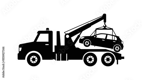 Silhouette of a tow truck lifting a car.