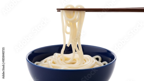 Isolated udon noodles being lifted from a blue bowl with wooden chopsticks for eating lunch