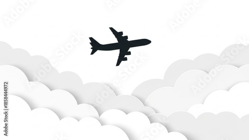 Airplane flying above the clouds in a clear sky viewed from below.