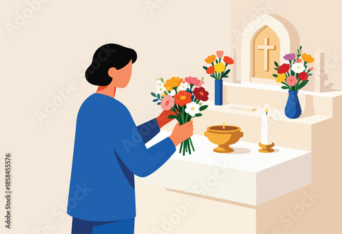 Person arranging colorful flowers at a simple altar with a candle
