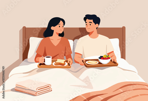 Couple enjoys breakfast in bed, sharing a romantic morning