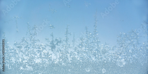 Bild auf Leinwand Close up photo of ice crystals on a frosty window pane surface, icy pattern, col