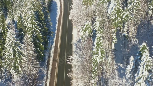 Aerial view of country road going through the snow covered landscape. Gorski kotar, Croatia