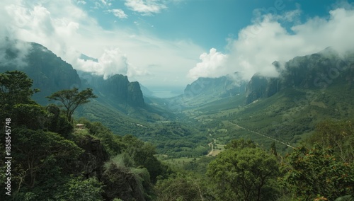 Green mountain range with a deep valley and clouds settling between hills, highlighting landscape preservation