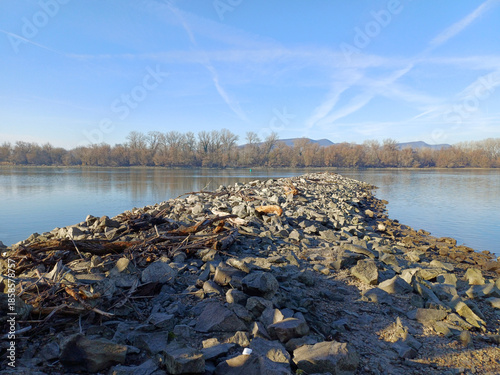 Stone spit into calm river
