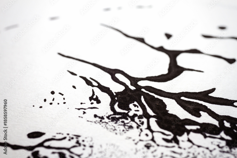 Fototapeta premium Extreme close up of black acrylic paint texture on paper. Selective focus.