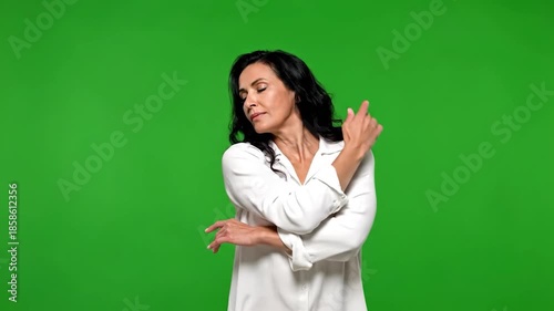 Woman dancing gracefully on a green screen background.