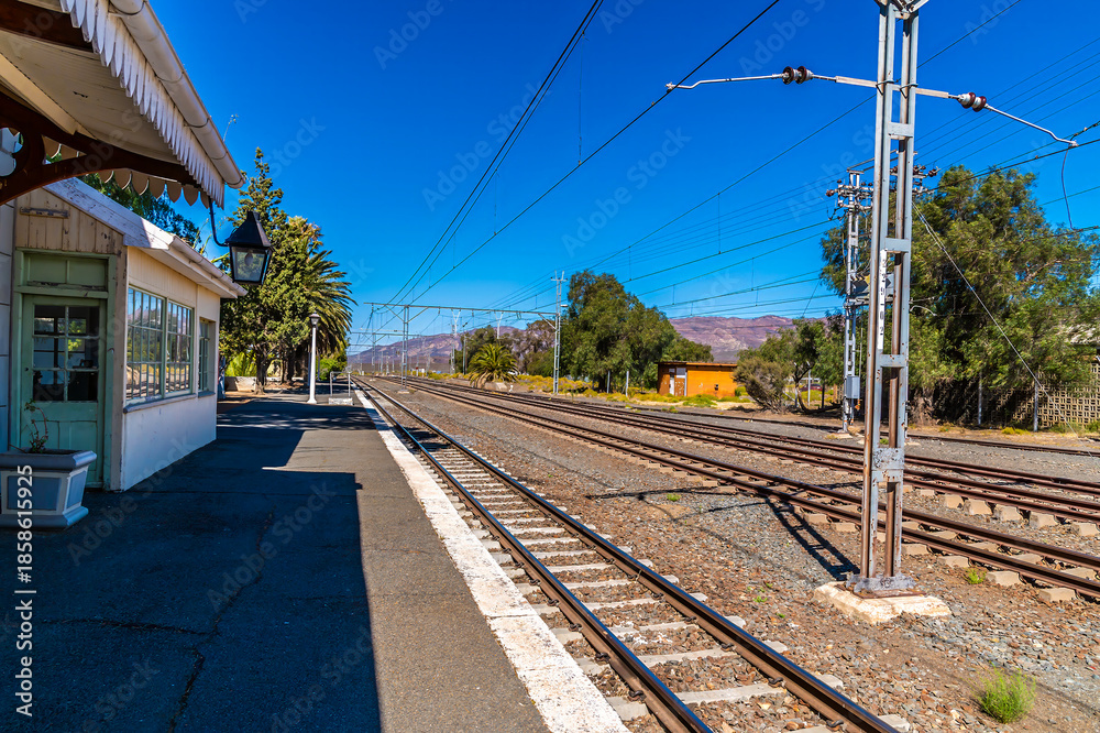 Fototapeta premium A view down the platform at the train station in the Victorian town of Matjiesfontein in the Western Cape in South Africa in springtime