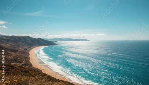 Aerial view of water and sky over a hill with beach, highlighting summer travel and nature landscape, World Environment Day