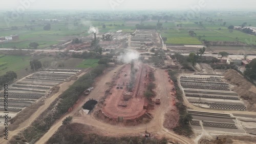 Drone footage of an old-style brick kiln in Okara, Pakistan. Aerial drone shot of a brick kiln factory where they are baking clay into bricks used for construction