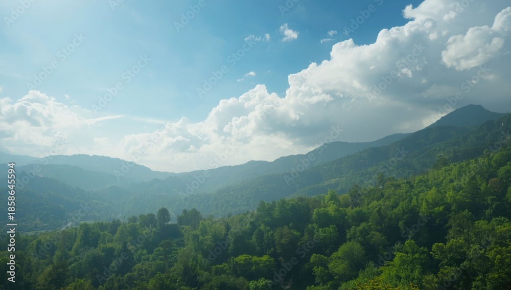 Fototapeta premium Cloudy sky over lush green mountains, suitable for scenic backdrop, Earth Day