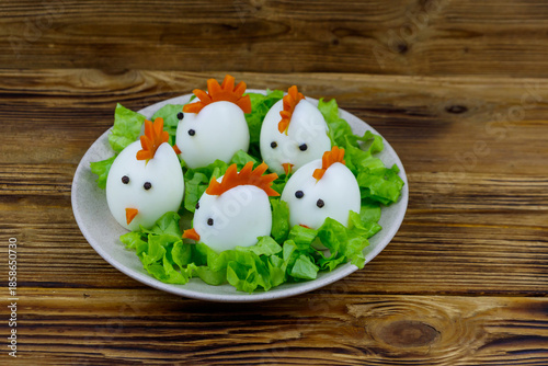 Wallpaper Mural Funny easter breakfast with boiled eggs as chicks on wooden table Torontodigital.ca