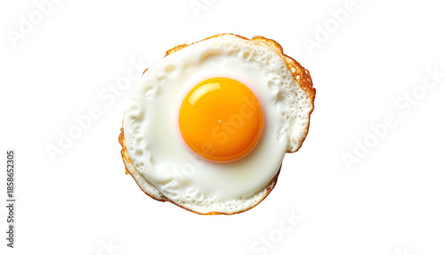Overhead shot of a fried egg with a bright yellow yolk and crispy white edges on black