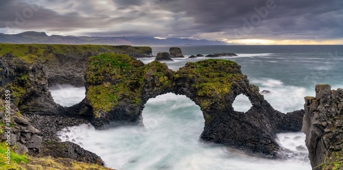 Photography panorama view of the wild and rugged coastline near Arnarstapi with the landmark