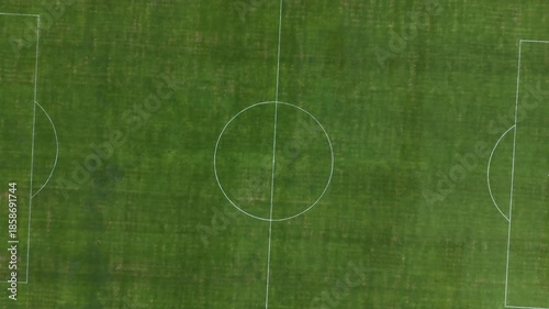 Aerial Top Down View of Empty Green Soccer Field Pitch with White Markings and Goals