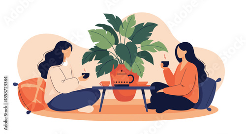 Two female friends sitting on the floor drinking tea and having a pleasant conversation in a cozy and relaxing atmosphere.