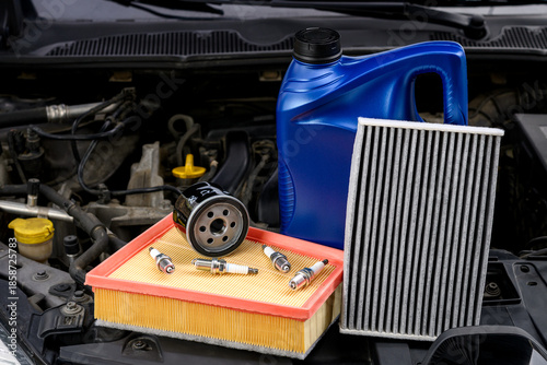 Filters for car and spark plugs under the hood of the car