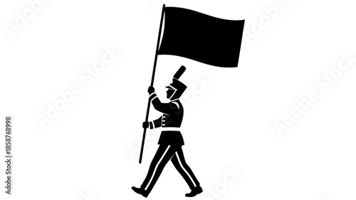 Silhouette of a person holding a flag and walking forward.