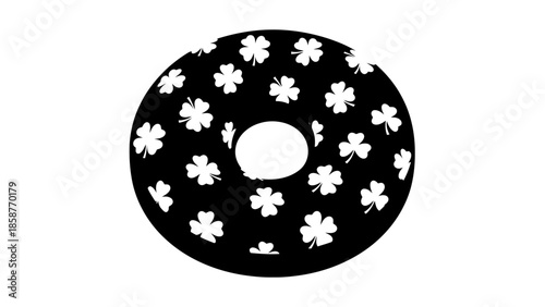 Black donut with white floral pattern on a white background.