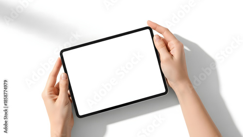 Hand-held tablet in studio shot: A person's hands delicately cradle a modern tablet device, its screen a blank canvas of possibilities, under soft natural light. 