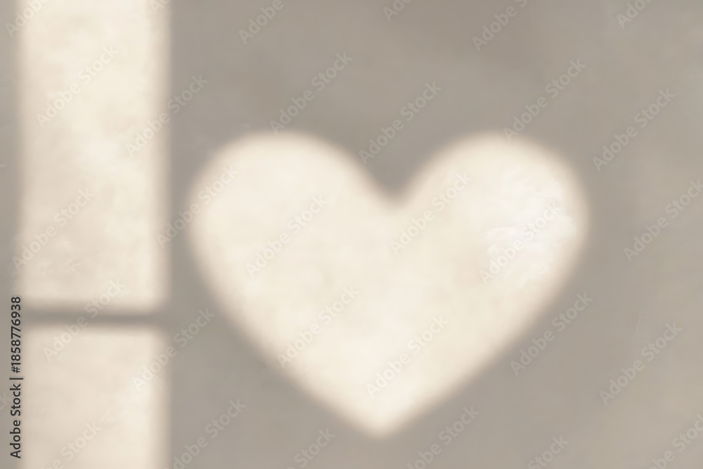 Fototapeta premium Heart shape shadow on wall from sunlight through window, lovely abstract background for design